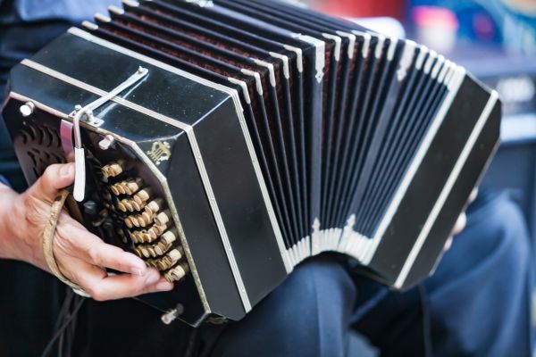 Close up image of someone playing a bandoneon.