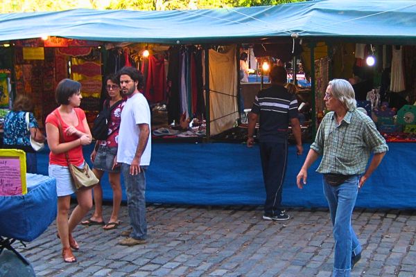 People walk past market stalls in Feria Plaza Francia, Recoleta in Buenos Aires