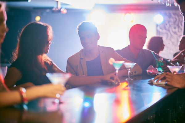 People sitting at bar with drinks