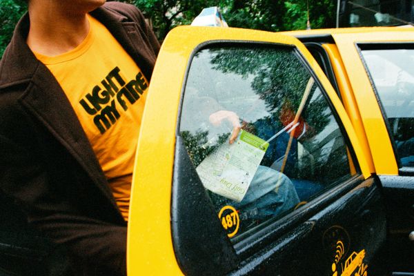 Man entering a yellow and black taxi in Buenos Aires, Argentina.