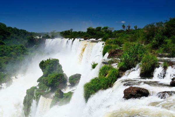 Water gushing over the edge of Iguazu Falls, creating a stunning cascade.