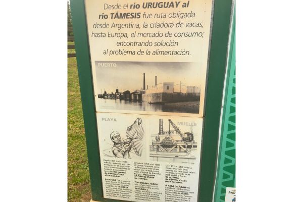 Information signs in the town of Liebig featuring old photos and illustrations about the history of the corned beef factory.